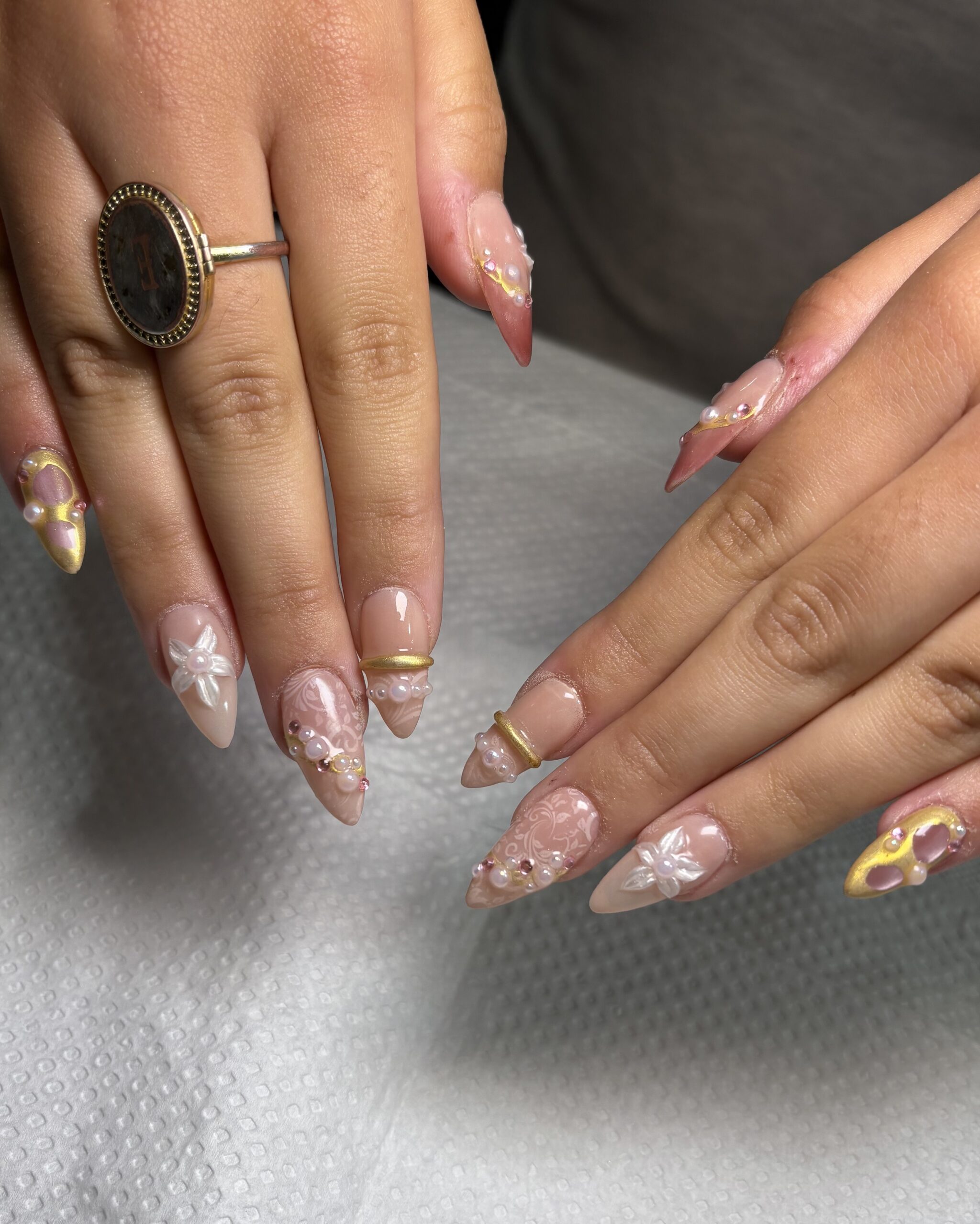 Custom pink nail set with white lace and chrome details at SR Studio