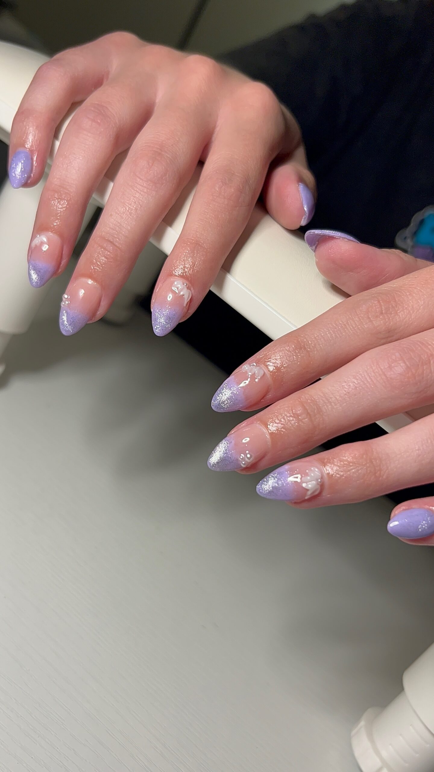 Short almond Gel-X nails with lavender ombre and dimensional details